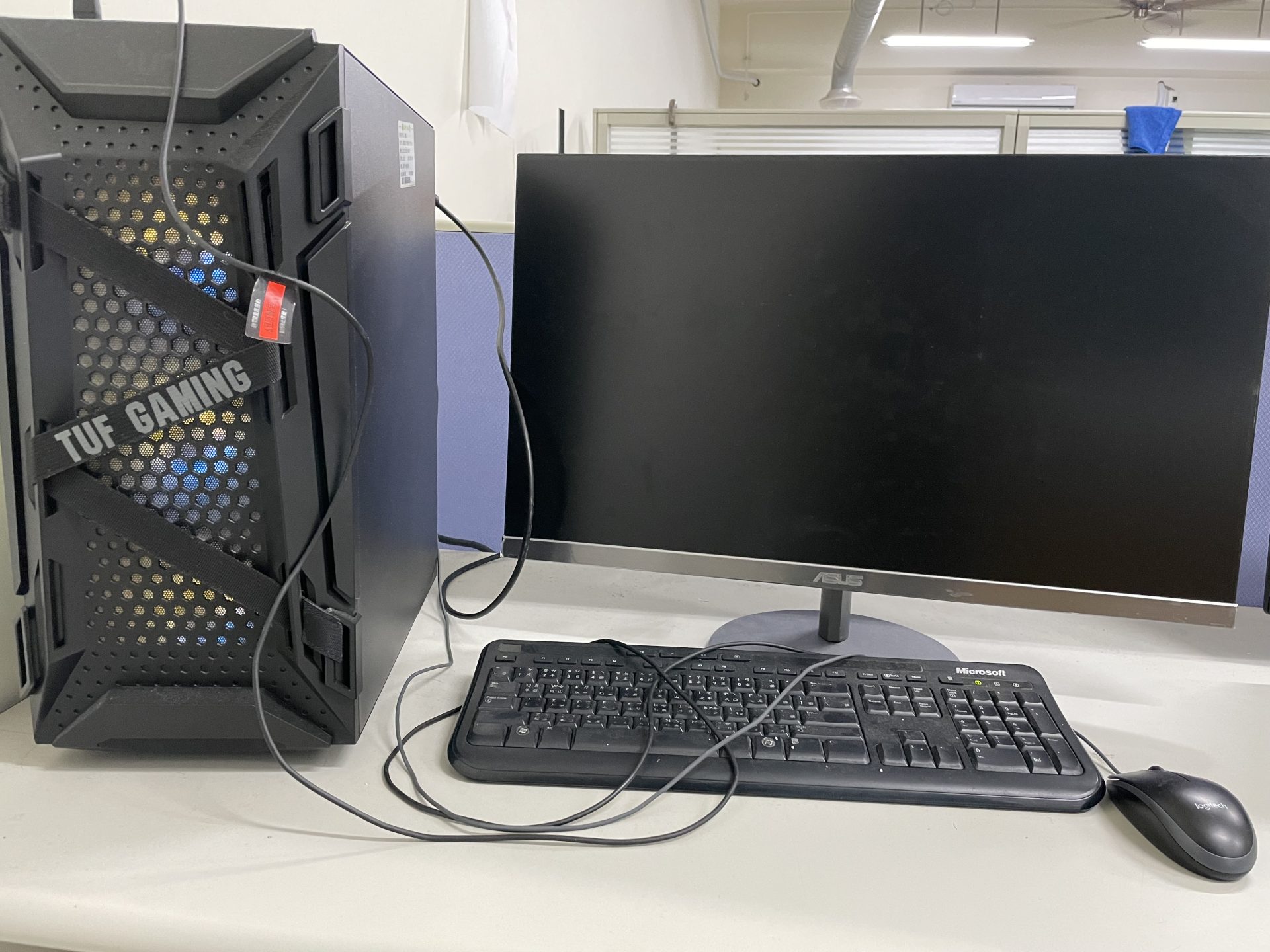 A desktop computer tower with a monitor, keyboard and mouse in the lab