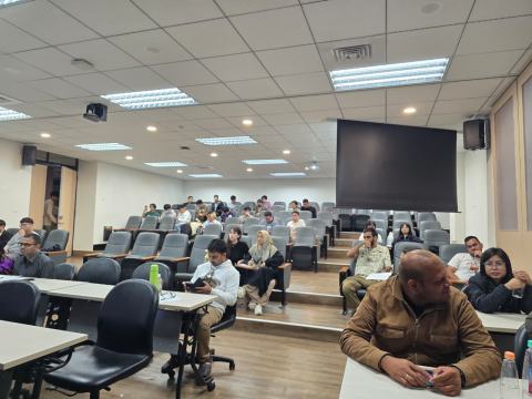 Students and researchers seated in the tiered seats of the lecture hall during the workshop.