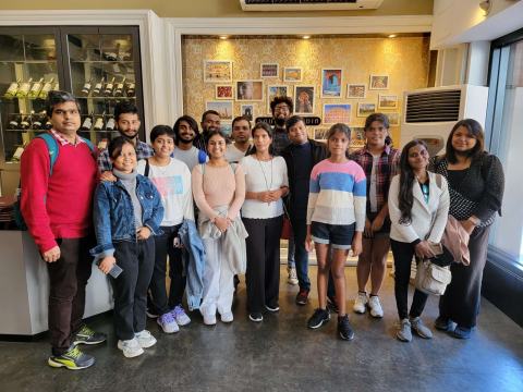 Group photo of lab members inside a restaurant.